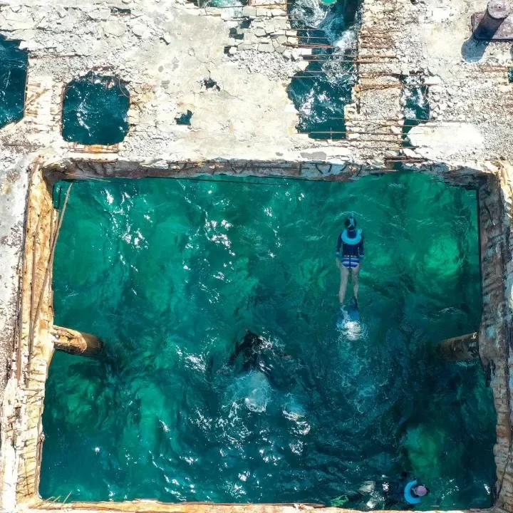 Aerial of a snorkeler inside the hull of the SS Sapona shipwreck