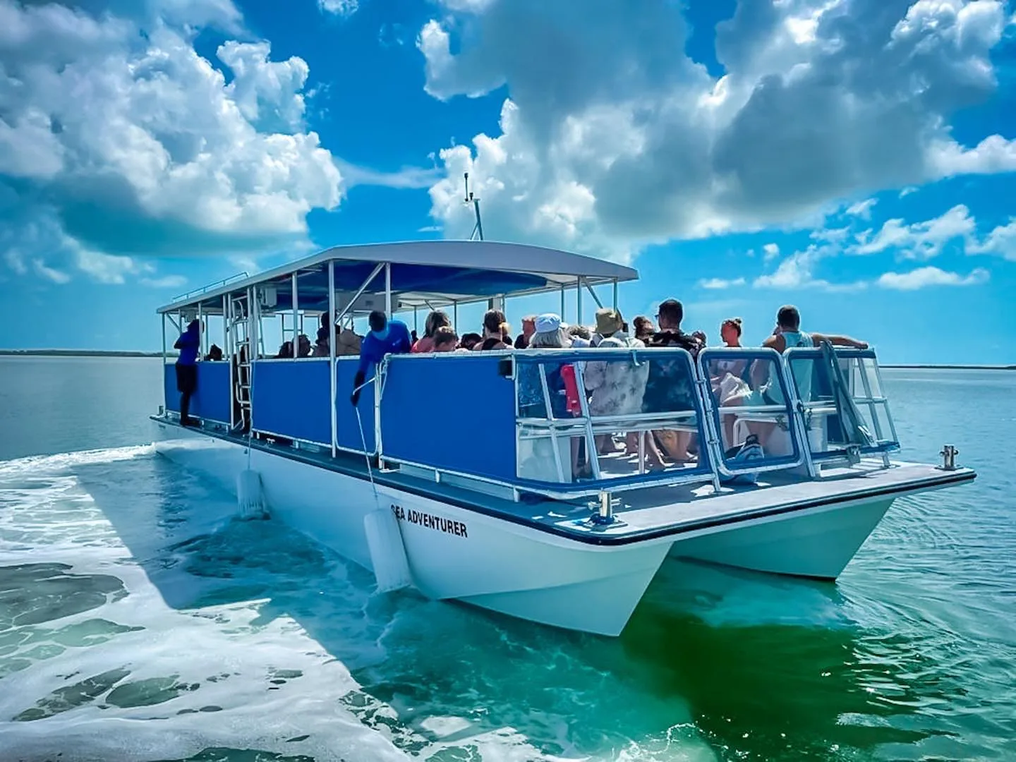 Bimini Blue Adventures tour boat with guests on turquoise water