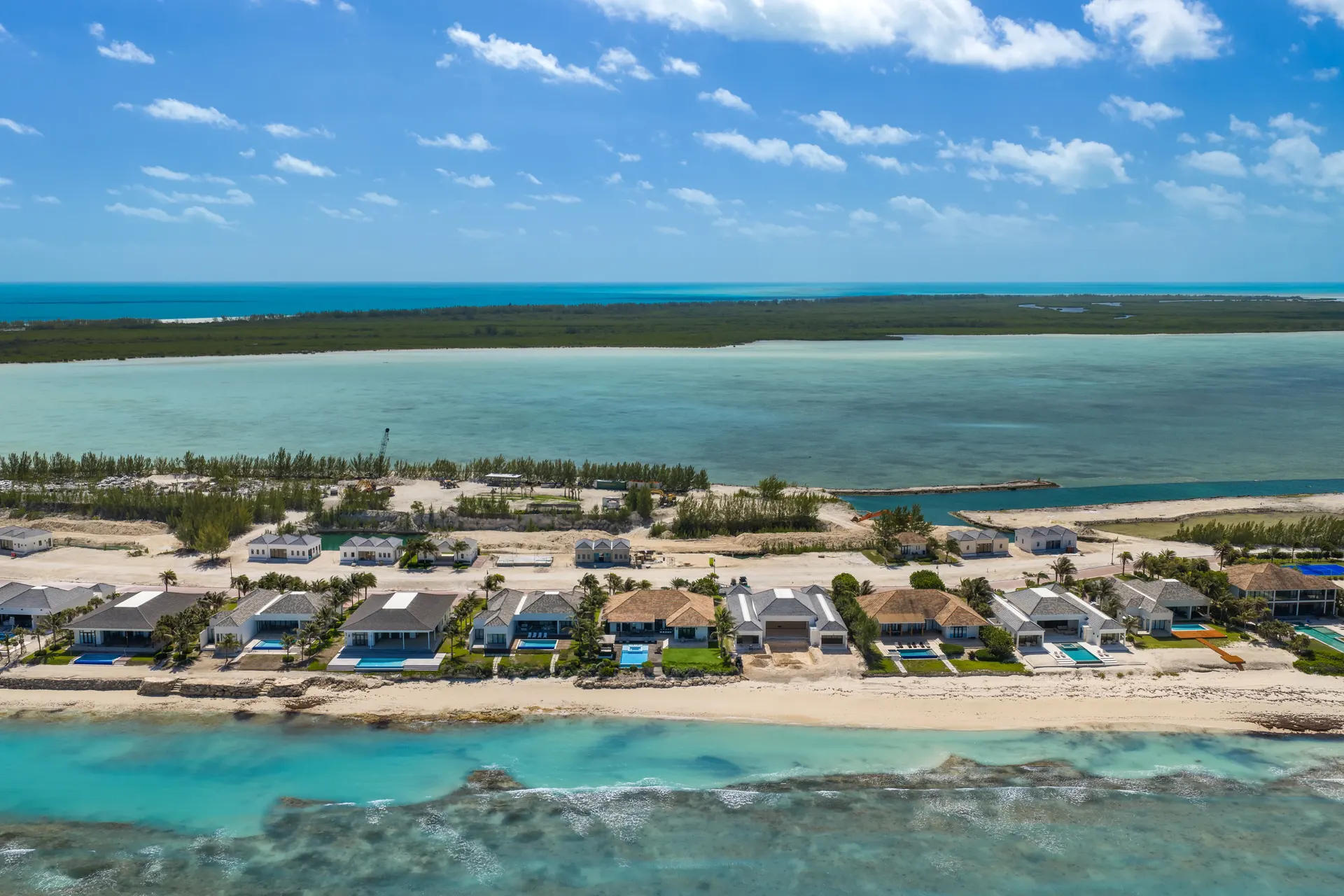 Aerial view of beachfront homes and turquoise water on the Bimini coast